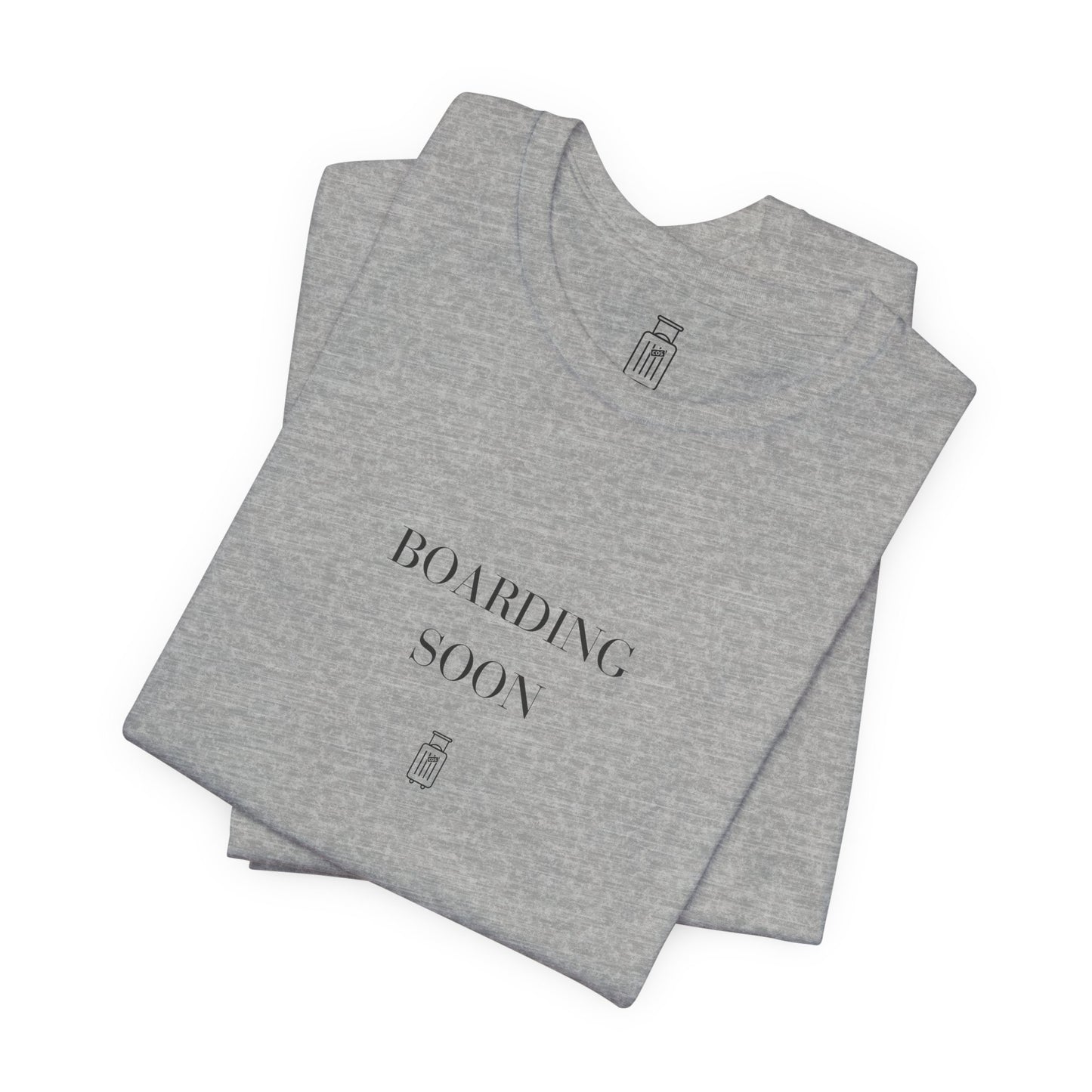 Folded Boarding Soon travel tee showing the front artwork and Journey Mark