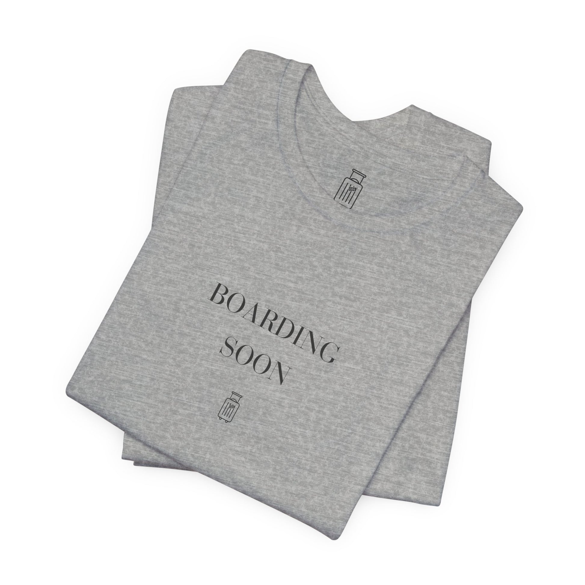 Folded Boarding Soon travel tee showing the front artwork and Journey Mark