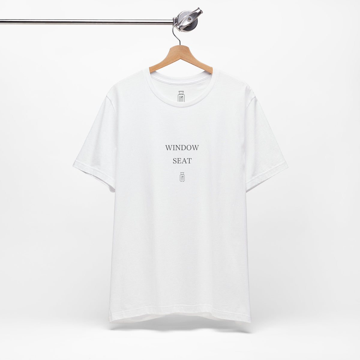 Window Seat travel tee displayed on a hanger in a neutral studio setting