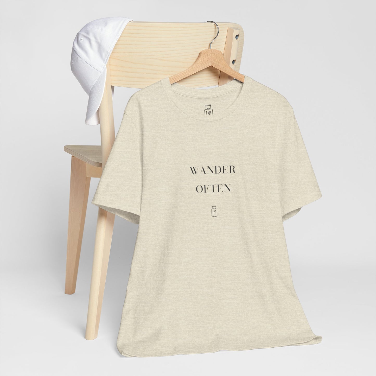 Wander Often travel tee displayed on a hanger in a neutral studio setting