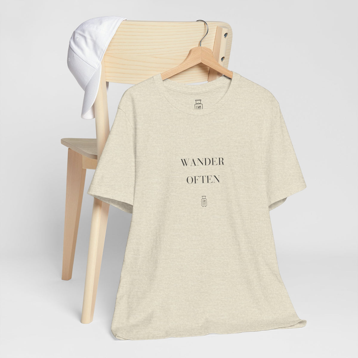 Wander Often travel tee displayed on a hanger in a neutral studio setting
