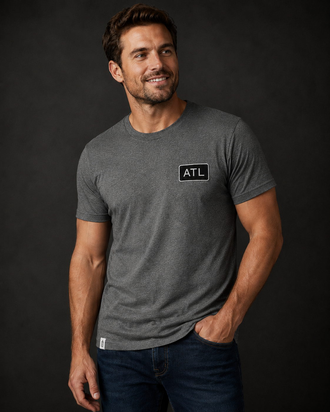 Man wearing a gray t-shirt with an 'ATL' logo on a black background