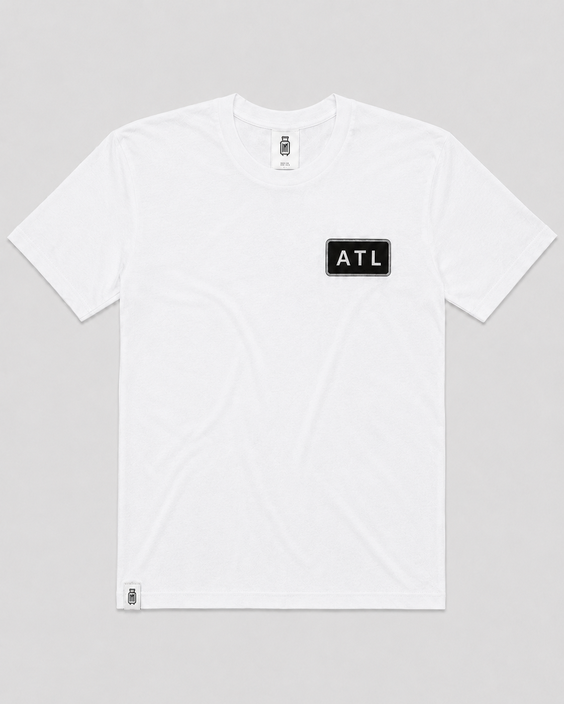 White t-shirt with 'ATL' logo on a gray background
