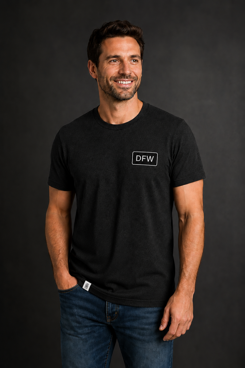 Man wearing a black t-shirt with 'DFW' logo against a dark background