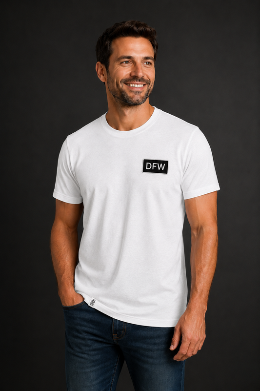 Man wearing a white t-shirt with a logo on a black background