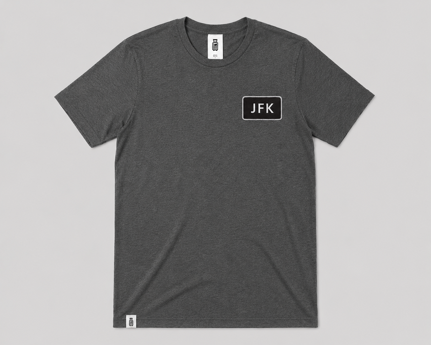 Gray t-shirt with 'JFK' logo on a gray background