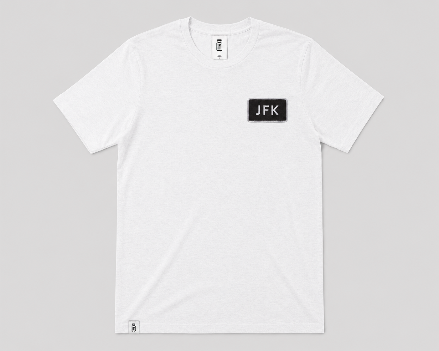 White t-shirt with 'JFK' logo on a gray background