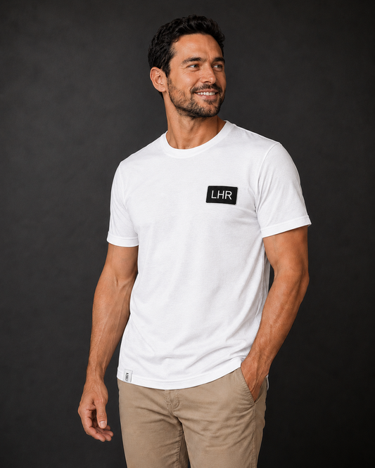 Man wearing a white t-shirt with 'LHR' logo against a black background