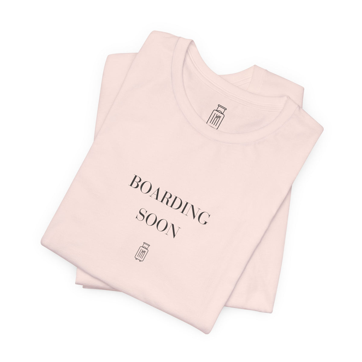 Boarding Soon travel T-shirt in Soft Pink, folded view
