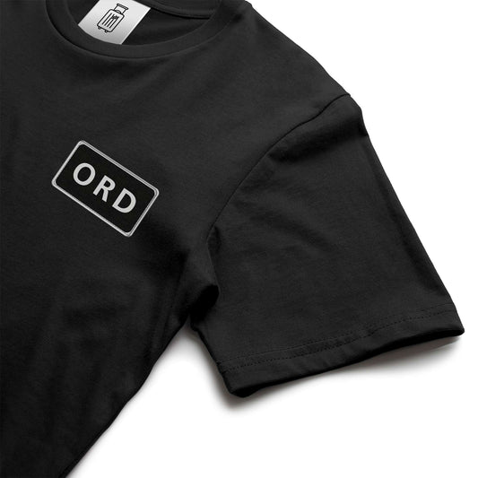 Close-up of ORD airport code design on ultra premium t-shirt black